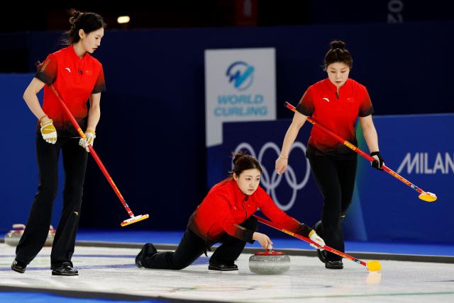 (LtoR) China's Jiang Jiayi, China's Su Tingyu and China's Dong Ziqi compete in the curling women's round robin between China and Britain during the Milano Cortina 2026 Winter Olympic Games at the Cortina Curling Olympic Stadium in Cortina d’Ampezzo on February 12, 2026. (Photo by Odd ANDERSEN / AFP)