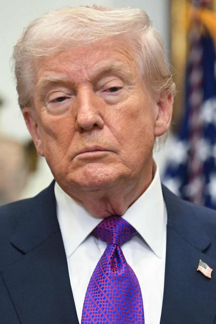 US President Donald Trump looks on during an announcement in the Roosevelt Room of the White House in Washington, DC on February 12, 2026. President Donald Trump on Thursday revoked a landmark scientific finding that underpins US regulations aimed at curbing planet-warming pollution, marking the administration's most far-reaching rollback of climate policy to date. (Photo by SAUL LOEB / AFP)