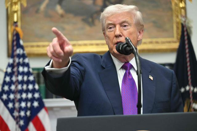 US President Donald Trump takes questions from reporters as after he made an announcement in the Roosevelt Room of the White House in Washington, DC on February 12, 2026. President Donald Trump on Thursday revoked a landmark scientific finding that underpins US regulations aimed at curbing planet-warming pollution, marking the administration's most far-reaching rollback of climate policy to date. (Photo by SAUL LOEB / AFP)