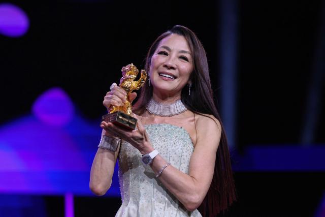 Malaysian actress Michelle Yeoh holds the trophy after being awarded the Honorary Golden Bear during the opening ceremony of the 76th Berlinale, Europe's first major film festival of the year, in Berlin on February 12, 2026. Yeoh is awarded the prize "in recognition of her outstanding achievements in film and cinema". (Photo by Ronny HARTMANN / AFP)