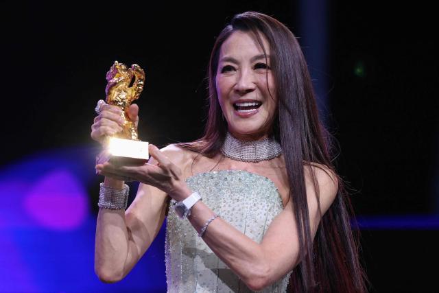 Malaysian actress Michelle Yeoh holds the trophy after being awarded the Honorary Golden Bear during the opening ceremony of the 76th Berlinale, Europe's first major film festival of the year, in Berlin on February 12, 2026. Yeoh is awarded the prize "in recognition of her outstanding achievements in film and cinema". (Photo by Ronny HARTMANN / AFP)