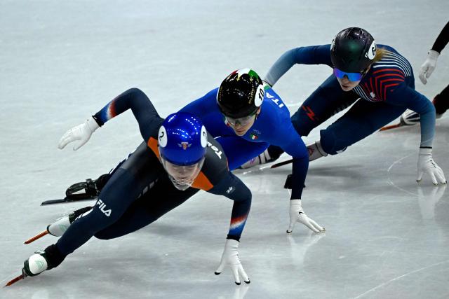 Netherlands' Xandra Velzeboer (L), Italy's Arianna Fontana (C) and France's Berenice Comby compete in the short track speed skating women's 500m quarter-final during the Milano Cortina 2026 Winter Olympic Games at Milano Ice Skating Arena in Milan on February 12, 2026. (Photo by WANG Zhao / AFP)