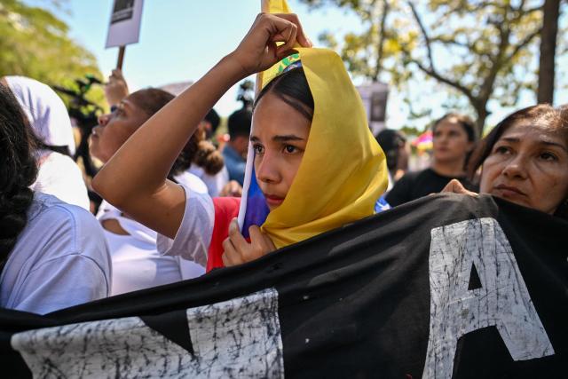 University students, opponents of the government, and relatives of political prisoners, take part in a march on the Youth Day in Caracas on February 12, 2026. The first major opposition demonstration after the fall of Nicolas Maduro during a US military incursion a month ago gathered thousands of people in Venezuelas capital on February 12, ahead of the approval of a historic amnesty law. (Photo by Juan BARRETO / AFP)