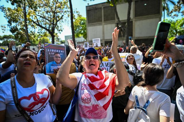 University students, opponents of the government, and relatives of political prisoners, shout slogans during a march on the Youth Day in Caracas on February 12, 2026. The first major opposition demonstration after the fall of Nicolas Maduro during a US military incursion a month ago gathered thousands of people in Venezuelas capital on February 12, ahead of the approval of a historic amnesty law. (Photo by Juan BARRETO / AFP)