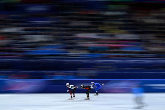 (L-R) Canada's Felix Roussel, China's Liu Shaoang and Italy's Thomas Nadalini compete in the short track speed skating men's 1000m quarter-final during the Milano Cortina 2026 Winter Olympic Games at Milano Ice Skating Arena in Milan on February 12, 2026. (Photo by WANG Zhao / AFP)