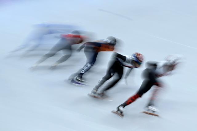 (R-L) Canada's Felix Roussel, South Korea's Hwang Dae-heon, Netherlands' Teun Boer, China's Liu Shaoang and Italy's Thomas Nadalini compete in the short track speed skating men's 1000m quarter-final during the Milano Cortina 2026 Winter Olympic Games at Milano Ice Skating Arena in Milan on February 12, 2026. (Photo by WANG Zhao / AFP)