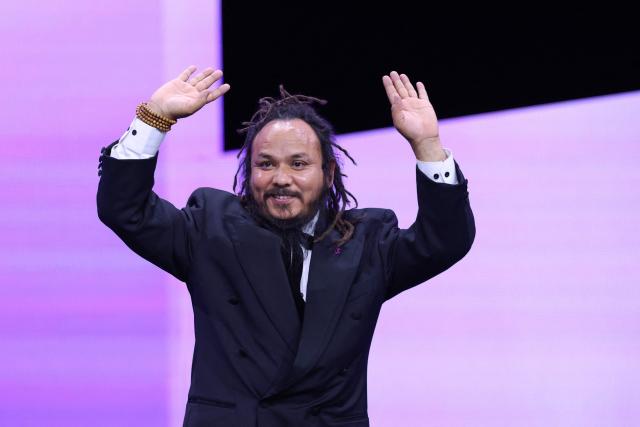 Jury member and Nepalese filmmaker Min Bahadur Bham takes the stage during the opening ceremony of the 76th Berlinale, Europe's first major film festival of the year, in Berlin on February 12, 2026. (Photo by Ronny HARTMANN / AFP)