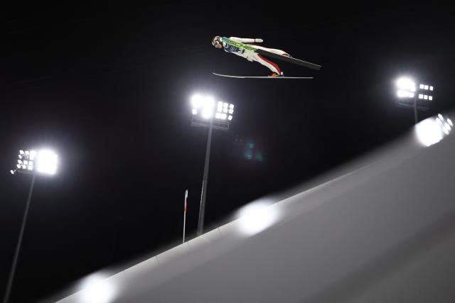 Austria's Jan Hoerl jumps during the men's ski jumping large hill training of the Milano Cortina 2026 Winter Olympic Games at Predazzo Ski Jumping Stadium in Predazzo (Val di Fiemme), on February 12, 2026. (Photo by Anne-Christine POUJOULAT / AFP)