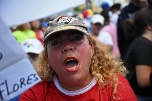 A demonstrator takes part in a march on International Youth Day in Caracas on February 12, 2026. (Photo by Federico PARRA / AFP)