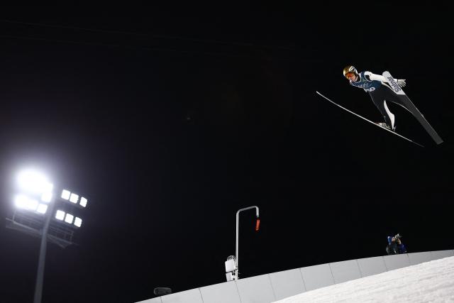 Slovenia's Domen Prevc jumps during the men's ski jumping large hill training of the Milano Cortina 2026 Winter Olympic Games at Predazzo Ski Jumping Stadium in Predazzo (Val di Fiemme), on February 12, 2026. (Photo by Anne-Christine POUJOULAT / AFP)