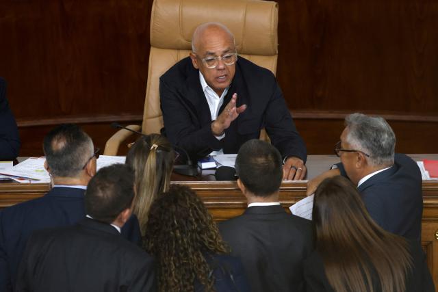 The president of Venezuela's National Assembly Jorge Rodriguez speaks with lawmakers during a debate on an amnesty bill proposed by Venezuela's interim president Delcy Rodriguez at the National Assembly in Caracas on February 12, 2026. The Venezuelan Parliament began on Thursday the final debate for the approval of a general amnesty law that is expected to lead to the mass release of political prisoners. (Photo by Pedro MATTEY / AFP)