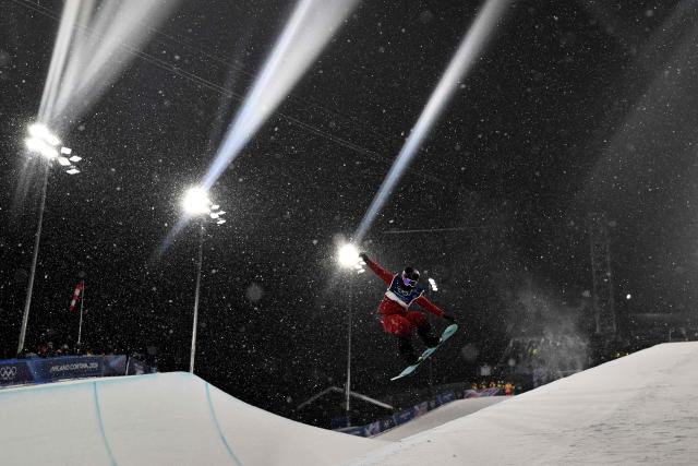 China's Cai Xuetong competes in the snowboard women's halfpipe final run 3 during the Milano Cortina 2026 Winter Olympic Games at Livigno Snow Park, in Livigno (Valtellina), on February 12, 2026. (Photo by Jeff PACHOUD / AFP)