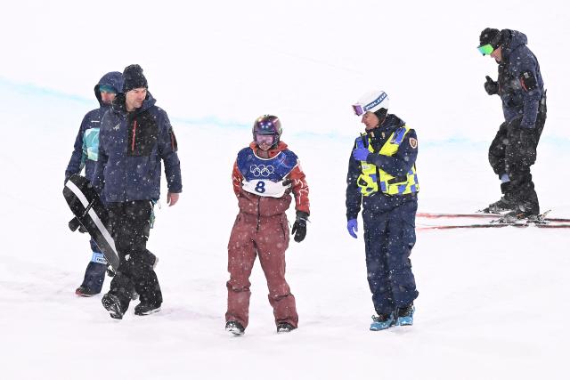 Canada's Elizabeth Hosking receives medical attention after crashing in the snowboard women's halfpipe final run 3 during the Milano Cortina 2026 Winter Olympic Games at Livigno Snow Park, in Livigno (Valtellina), on February 12, 2026. (Photo by Kirill KUDRYAVTSEV / AFP)