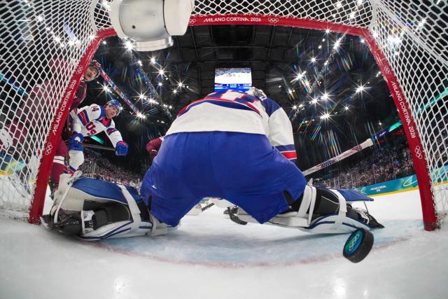 Latvia's #09 Renars Krastenbergs scores the 1-1 goal during the men's preliminary round Group C Ice Hockey match between Latvia and USA at the Milano Santagiulia Ice Hockey Arena during the Milano Cortina 2026 Winter Olympic Games in Milan, on February 12, 2026. (Photo by POOL / AFP)
