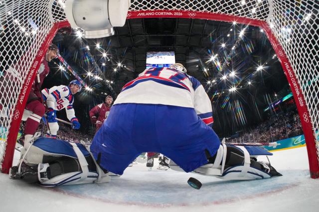 Latvia's #09 Renars Krastenbergs scores the 1-1 goal during the men's preliminary round Group C Ice Hockey match between Latvia and USA at the Milano Santagiulia Ice Hockey Arena during the Milano Cortina 2026 Winter Olympic Games in Milan, on February 12, 2026. (Photo by POOL / AFP)