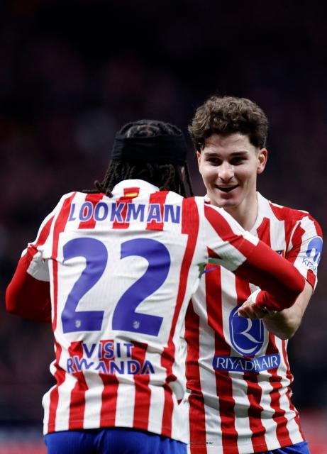 Atletico Madrid's English forward #22 Ademola Lookman celebrates with Atletico Madrid's Argentine forward #19 Julian Alvarez after scoring his team's third goal during the Spanish Copa del Rey (King's Cup) semi final first leg football match between Club Atletico de Madrid and FC Barcelona at Metropolitano Stadium in Madrid on February 12, 2026. (Photo by Oscar DEL POZO / AFP)