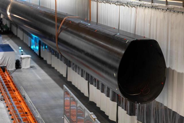 This photograph shows a mast at the SolidSail Mast Factory in lanester, western France, on February 12, 2026. This factory started production of masts contributing to the decarbonation of maritime transport but also have the ability to make huge composite pieces for aeronotic, aerospatial, defence, transport and wind energy industry's. (Photo by Fred TANNEAU / AFP)