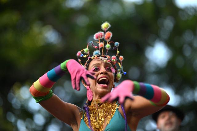 A reveller attends the parade of the Loucura Suburbana (Suburban Craziness) street carnival group at the Engenho de Dentro neighborhood in Rio de Janeiro, Brazil on February 12, 2026. (Photo by Mauro PIMENTEL / AFP)