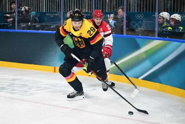 Germany's #29 Leon Draisaitl (L) and Denmark's #25 Oliver Lauridsen fight for the puck  during the men's preliminary round Group C Ice Hockey match between Germany and Denmark at the Milano Rho Ice Hockey Arena at the Milano Cortina 2026 Winter Olympic Games in Milan, on February 12, 2026. (Photo by Piero CRUCIATTI / AFP)