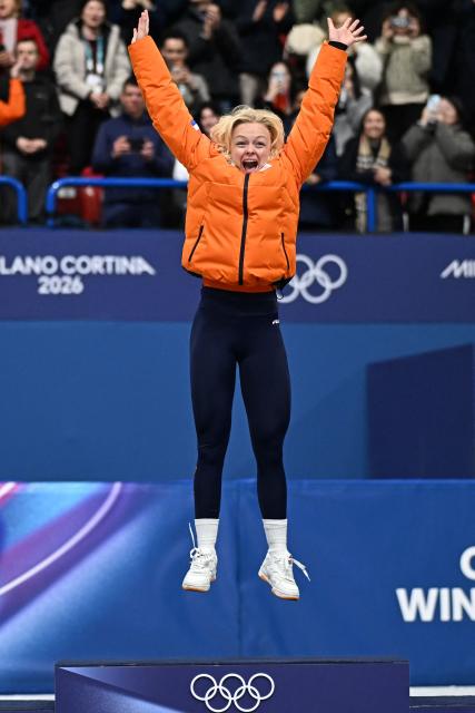 Gold medalist Netherlands' Xandra Velzeboer poses on the podium after competing in the short track speed skating women's 500m final during the Milano Cortina 2026 Winter Olympic Games at Milano Ice Skating Arena in Milan on February 12, 2026. (Photo by Gabriel BOUYS / AFP)