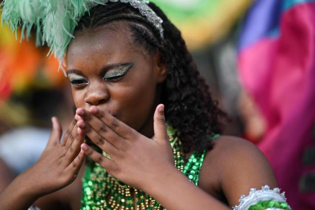 A reveller attends the parade of the Loucura Suburbana (Suburban Craziness) street carnival group at the Engenho de Dentro neighborhood in Rio de Janeiro, Brazil on February 12, 2026. (Photo by Mauro PIMENTEL / AFP)