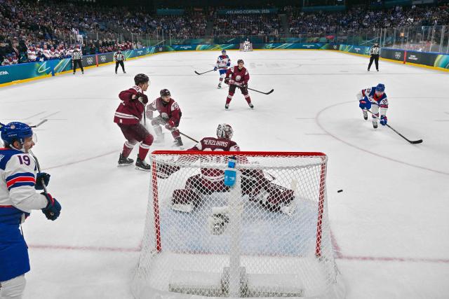 USA's #29 Brock Nelson (R) scores their fourth goal during the men's preliminary round Group C Ice Hockey match between Latvia and USA at the Milano Santagiulia Ice Hockey Arena during the Milano Cortina 2026 Winter Olympic Games in Milan, on February 12, 2026. (Photo by Alexander NEMENOV / POOL / AFP)