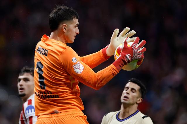 Atletico Madrid's Argentine goalkeeper #01 Juan Musso saves the ball during the Spanish Copa del Rey (King's Cup) semi final first leg football match between Club Atletico de Madrid and FC Barcelona at Metropolitano Stadium in Madrid on February 12, 2026. (Photo by Oscar DEL POZO / AFP)