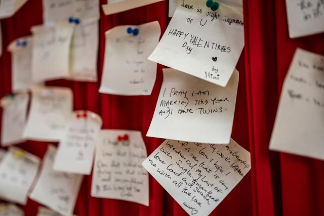 Handwritten notes are pinned on a red `love note wall` at The Locale restaurant in Lagos, on February 11, 2026. (Photo by OLYMPIA DE MAISMONT / AFP)