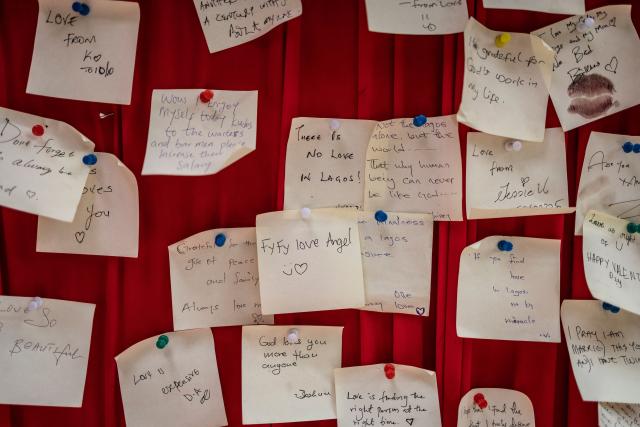 Handwritten notes are pinned on a red `love note wall` at The Locale restaurant in Lagos, on February 11, 2026. (Photo by OLYMPIA DE MAISMONT / AFP)