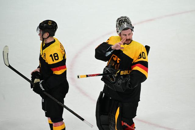 Germany's #30 Philipp Grubauer (R) and Germany's #18 Tim Stutzle react after winning the men's preliminary round Group C Ice Hockey match between Germany and Denmark at the Milano Rho Ice Hockey Arena at the Milano Cortina 2026 Winter Olympic Games in Milan, on February 12, 2026. (Photo by Piero CRUCIATTI / AFP)