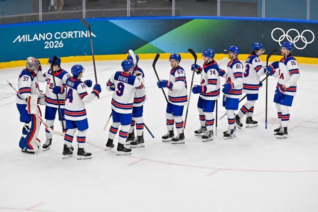 Team USA players celebrate winning their men's preliminary round Group C Ice Hockey match between Latvia and USA at the Milano Santagiulia Ice Hockey Arena during the Milano Cortina 2026 Winter Olympic Games in Milan, on February 12, 2026. (Photo by Alexander NEMENOV / AFP)