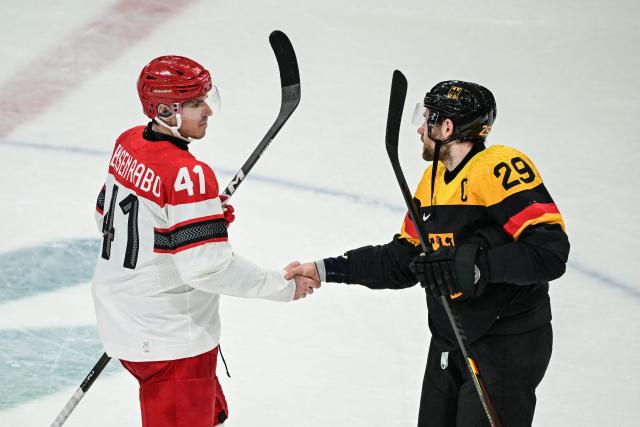 Germany's #29 Leon Draisaitl (R) shakes hands with Denmark's #41 Jesper Jensen Aabo after the men's preliminary round Group C Ice Hockey match between Germany and Denmark at the Milano Rho Ice Hockey Arena at the Milano Cortina 2026 Winter Olympic Games in Milan, on February 12, 2026. (Photo by Piero CRUCIATTI / AFP)