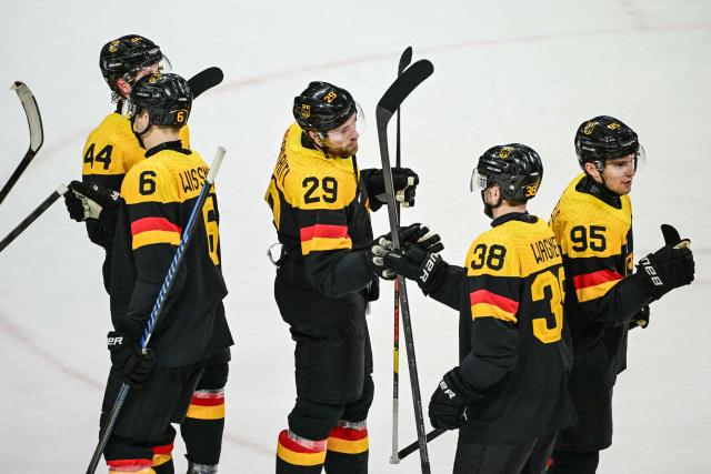 Germany's player celebrate fter winning the men's preliminary round Group C Ice Hockey match between Germany and Denmark at the Milano Rho Ice Hockey Arena at the Milano Cortina 2026 Winter Olympic Games in Milan, on February 12, 2026. (Photo by Piero CRUCIATTI / AFP)