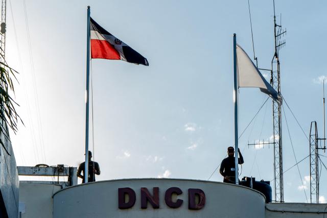 Dominican police officers stand on the roof of the headquarters of the National Drug Control Directorate in Santo Domingo on February 12, 2026. The United States said on February 12, 2026, it was closing its Drug Enforcement Administration office in the Dominican Republic over unspecified corruption claims. (Photo by Danny Polaco / AFP)