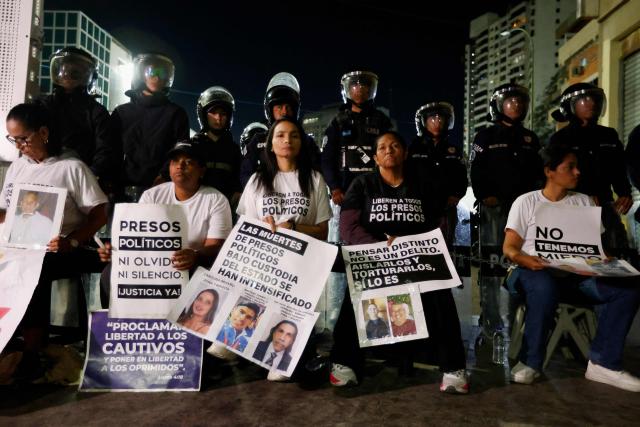 Relatives of political prisoners hold signs as they take part in a protest outside the Bolivarian National Police (PNB) Zone 7 prison in Caracas on February 12, 2026. Venezuela's legislature on February 12 postponed the adoption of a landmark amnesty bill expected to lead to the release of hundreds of political prisoners. (Photo by Pedro MATTEY / AFP)