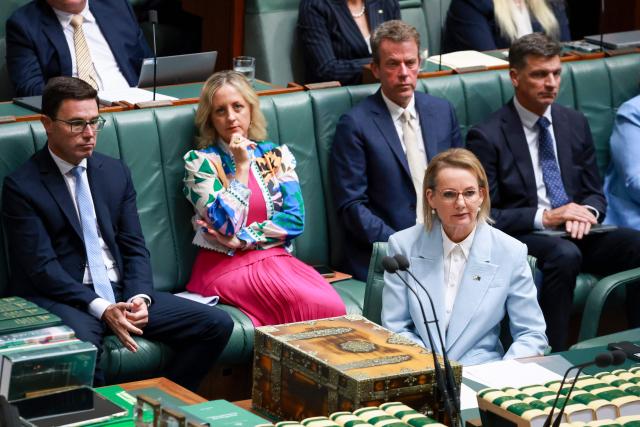 Australias opposition Liberal Party leader Sussan Ley, the party's first female leader, sits in front of members of her front bench, including Angus Taylor (R), during Question Time at Federal Parliament in Canberra on February 11, 2026. Australia's centre-right opposition Liberal Party on February 13 elected as leader a conservative who lobbied to drop its commitment to net zero emissions, local media reported. Angus Taylor -- a former energy minister -- replaces Sussan Ley, the party's first female leader who had been in office for less than a year. (Photo by DAVID GRAY / AFP)