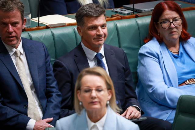 Australias opposition Liberal Party member Angus Taylor (C) sits behind leader Sussan Ley, the party's first female leader, during Question Time at Federal Parliament in Canberra on February 11, 2026. Australia's centre-right opposition Liberal Party on February 13 elected as leader a conservative who lobbied to drop its commitment to net zero emissions, local media reported. Angus Taylor -- a former energy minister -- replaces Sussan Ley, the party's first female leader who had been in office for less than a year. (Photo by DAVID GRAY / AFP)