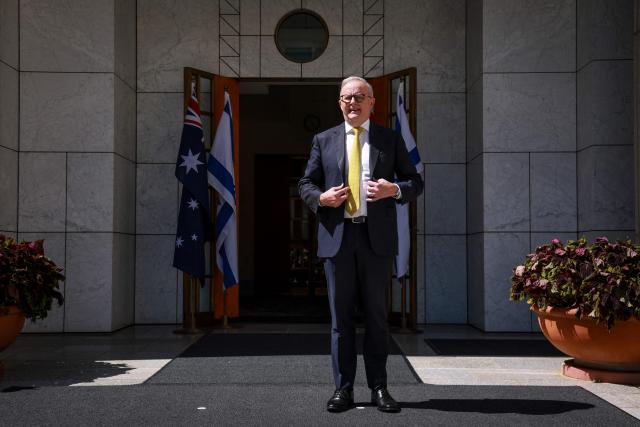 Australia’s Prime Minister Anthony Albanese stands outside the entrance to his office at Parliament House in Canberra on February 11, 2026. Australia's centre-right opposition Liberal Party on February 13 elected as leader a conservative who lobbied to drop its commitment to net zero emissions, local media reported. Angus Taylor -- a former energy minister -- replaces Sussan Ley, the party's first female leader who had been in office for less than a year. (Photo by DAVID GRAY / AFP)