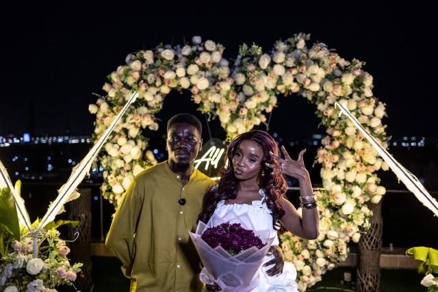 James Obiri and his girlfriend Fehintola Da-Silva pose for a photograph after a surprise marriage proposal on the rooftop of a private residence in Lagos on February 7, 2026. (Photo by OLYMPIA DE MAISMONT / AFP)