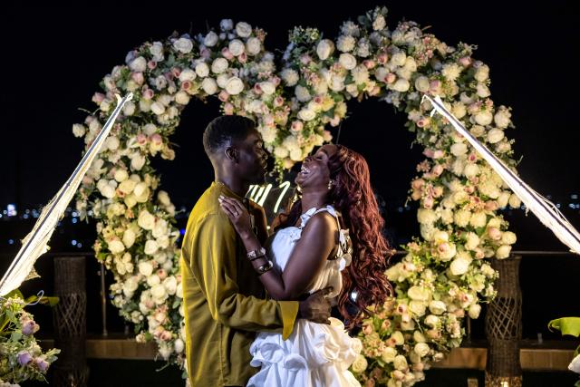 James Obiri hugs his girlfriend Fehintola Da-Silva after a surprise marriage proposal on the rooftop of a private residence in Lagos on February 7, 2026. (Photo by OLYMPIA DE MAISMONT / AFP)