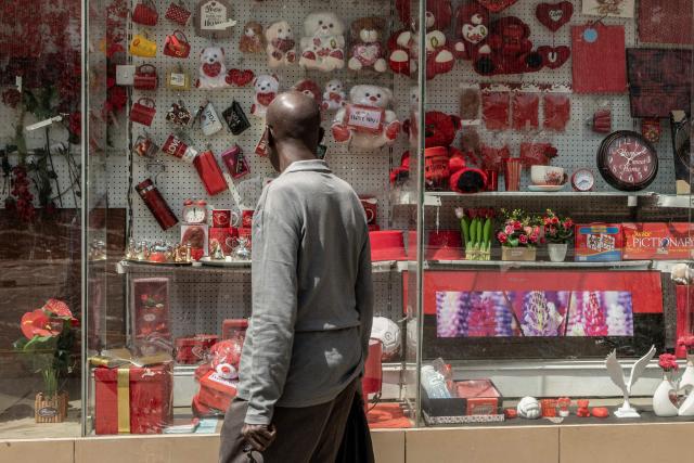 A pedestrian looks at the display of House of Leather, decorated with gift ahead of Valentine's Day in Nairobi, on February 11, 2026. (Photo by SIMON MAINA / AFP)