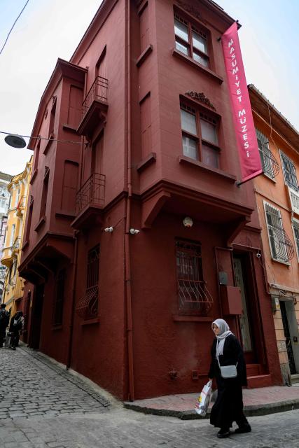 A pedestrian walks past The Museum of Innocence in Istanbul on February 10, 2026. On a cobbled street in Cukurcuma, a district known for its antiques shops on Istanbul's European side, the story penned by Nobel Literature Prize-winning Turkish author Orhan Pamuk has been brought to life inside the walls of a red-painted house. (Photo by Yasin AKGUL / AFP)