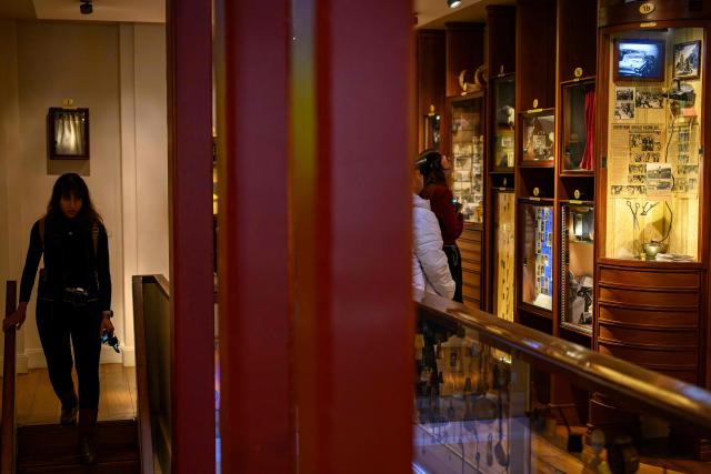 A visitor goes down the stairs inside The Museum of Innocence in Istanbul on February 10, 2026. On a cobbled street in Cukurcuma, a district known for its antiques shops on Istanbul's European side, the story penned by the Nobel Literature Prize-winning Turkish author has been brought to life inside the walls of a red-painted house. (Photo by Yasin AKGUL / AFP)