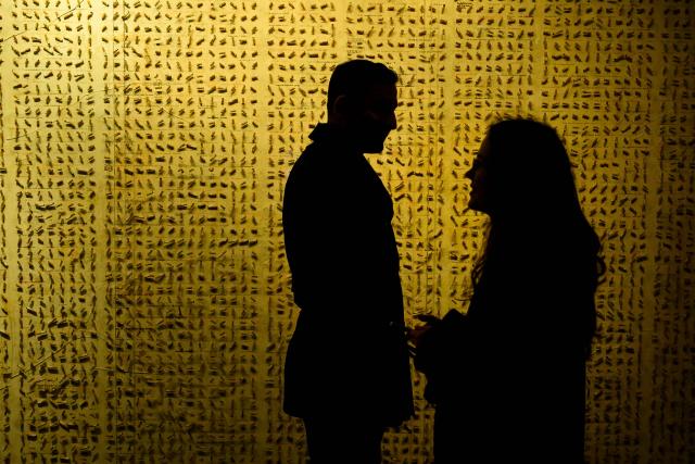 Visitors stand in front of a wall in The Museum of Innocence  in Istanbul on February 10, 2026. On a cobbled street in Cukurcuma, a district known for its antiques shops on Istanbul's European side, the story penned by Nobel Literature Prize-winning Turkish author Orhan Pamuk has been brought to life inside the walls of a red-painted house. (Photo by Yasin AKGUL / AFP)