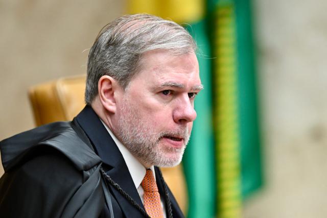 (FILES) Judge Dias Toffoli looks on during a trial of the regulation of social networks at the Brazilian Supreme Court in Brasilia on June 4, 2025. Brazilian Supreme Court Justice Dias Toffoli resigned on February 12, 2026, from leading an investigation into financial fraud after being questioned about his ties to the banker at the center of a scandal that is shaking up the South American powerhouse. In a plot that has monopolized the attention of the local media, what began with the insolvency liquidation of businessman Daniel Vorcaro's Master Bank has led to an investigation revealing suspicious connections with politics and the justice system. (Photo by EVARISTO SA / AFP)