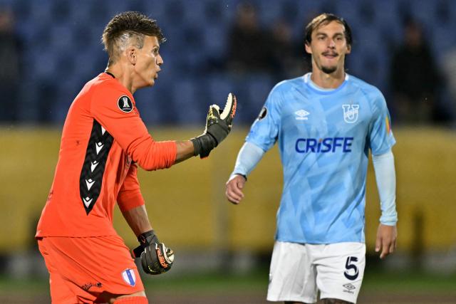 TOPSHOT - Juventud's goalkeeper #01 Sebastian Sosa celebrates after saving a shot from Universidad Catolica's Argentine midfielder #05 Jeronimo Cacciabue during the penalty shootout of the Copa Libertadores phase one second-leg football match between Ecuador's Universidad Catolica and Uruguay's Juventud at the Olimpico Atahualpa stadium in Quito on February 12, 2026. (Photo by Rodrigo BUENDIA / AFP)