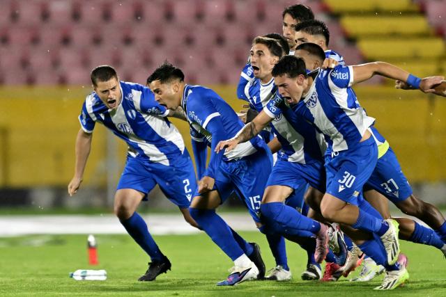 Players of Juventud celebrate after winning the penalty shootout of the Copa Libertadores phase one second-leg football match between Ecuador's Universidad Catolica and Uruguay's Juventud at the Olimpico Atahualpa stadium in Quito on February 12, 2026. (Photo by Rodrigo BUENDIA / AFP)