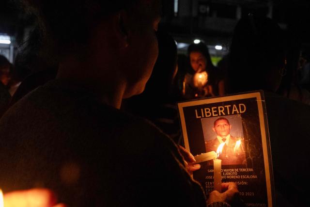 Relatives of political prisoners light candles during a vigil outside El Rodeo I prison in Guatire, Miranda state, Venezuela, on February 12, 2026. Venezuela's legislature on February 12 postponed the adoption of a landmark amnesty bill expected to lead to the release of hundreds of political prisoners. (Photo by Maryorin Mendez / AFP)