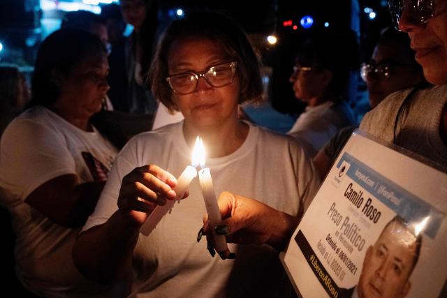 Relatives of political prisoners light candles during a vigil outside El Rodeo I prison in Guatire, Miranda state, Venezuela, on February 12, 2026. Venezuela's legislature on February 12 postponed the adoption of a landmark amnesty bill expected to lead to the release of hundreds of political prisoners. (Photo by Maryorin Mendez / AFP)