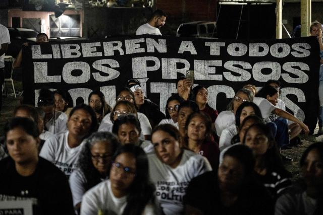 Relatives of political prisoners take part in a vigil outside El Rodeo I prison in Guatire, Miranda state, Venezuela, on February 12, 2026. Venezuela's legislature on February 12 postponed the adoption of a landmark amnesty bill expected to lead to the release of hundreds of political prisoners. (Photo by Maryorin Mendez / AFP)